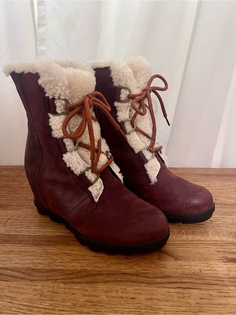 Sorel Joan of Arctic Wedge II burgundy boots with cozy white shearling.